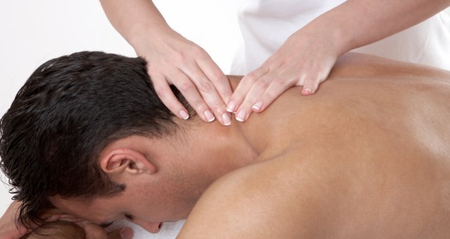 Hands massaging a man’s neck